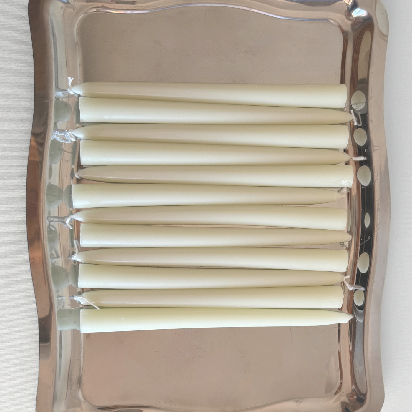 Cereria Graziani Tapered Dinner Candles, set of ivory wax tapers with smooth, gently tapered ends and visible wicks.