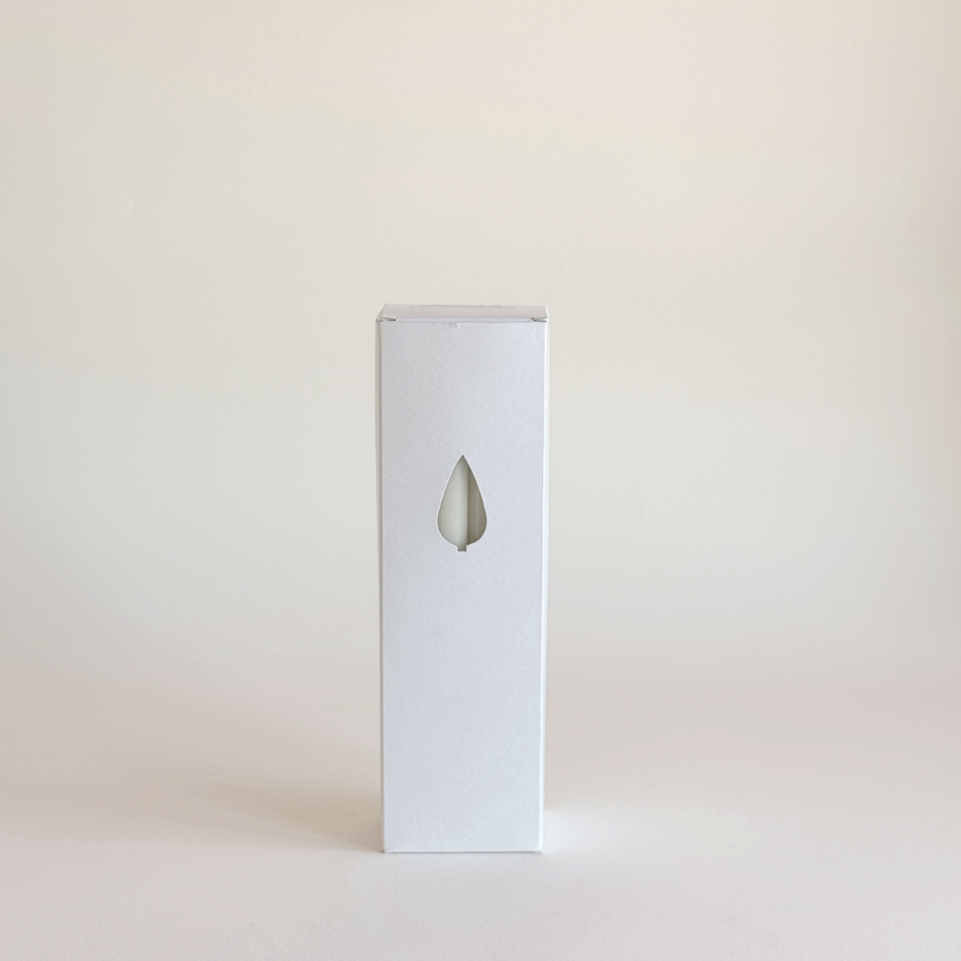 Cereria Graziani Tapered Dinner Candles in an ivory wax set, shown in a tall white box with a teardrop window.