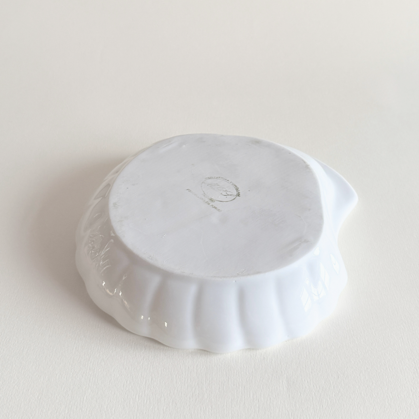 Italian porcelain shell dish styled with bread on the table