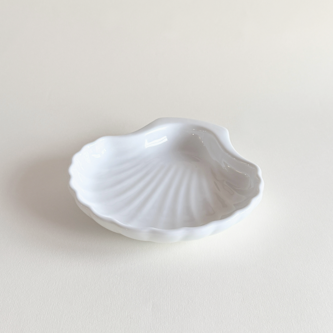 White Italian porcelain shell-form oven dish on a neutral surface