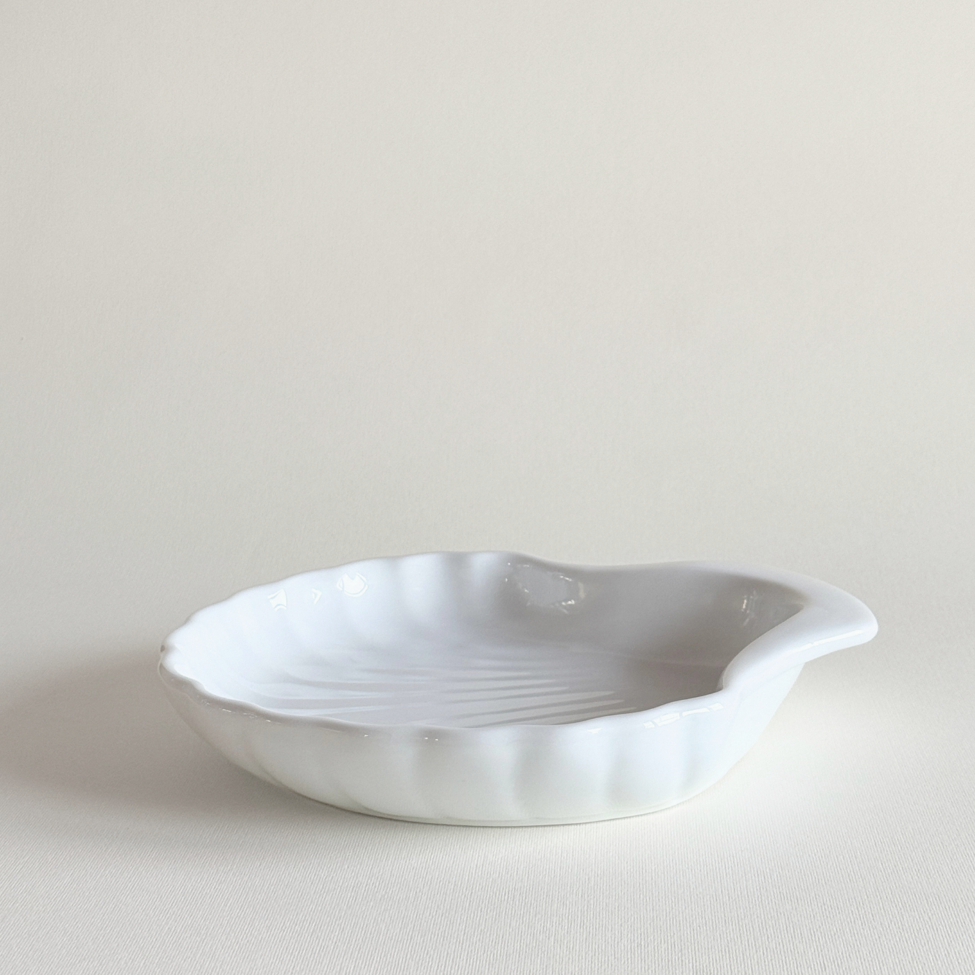 Close view of the shell dish's ridged white porcelain surface