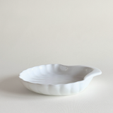 Close view of the shell dish's ridged white porcelain surface