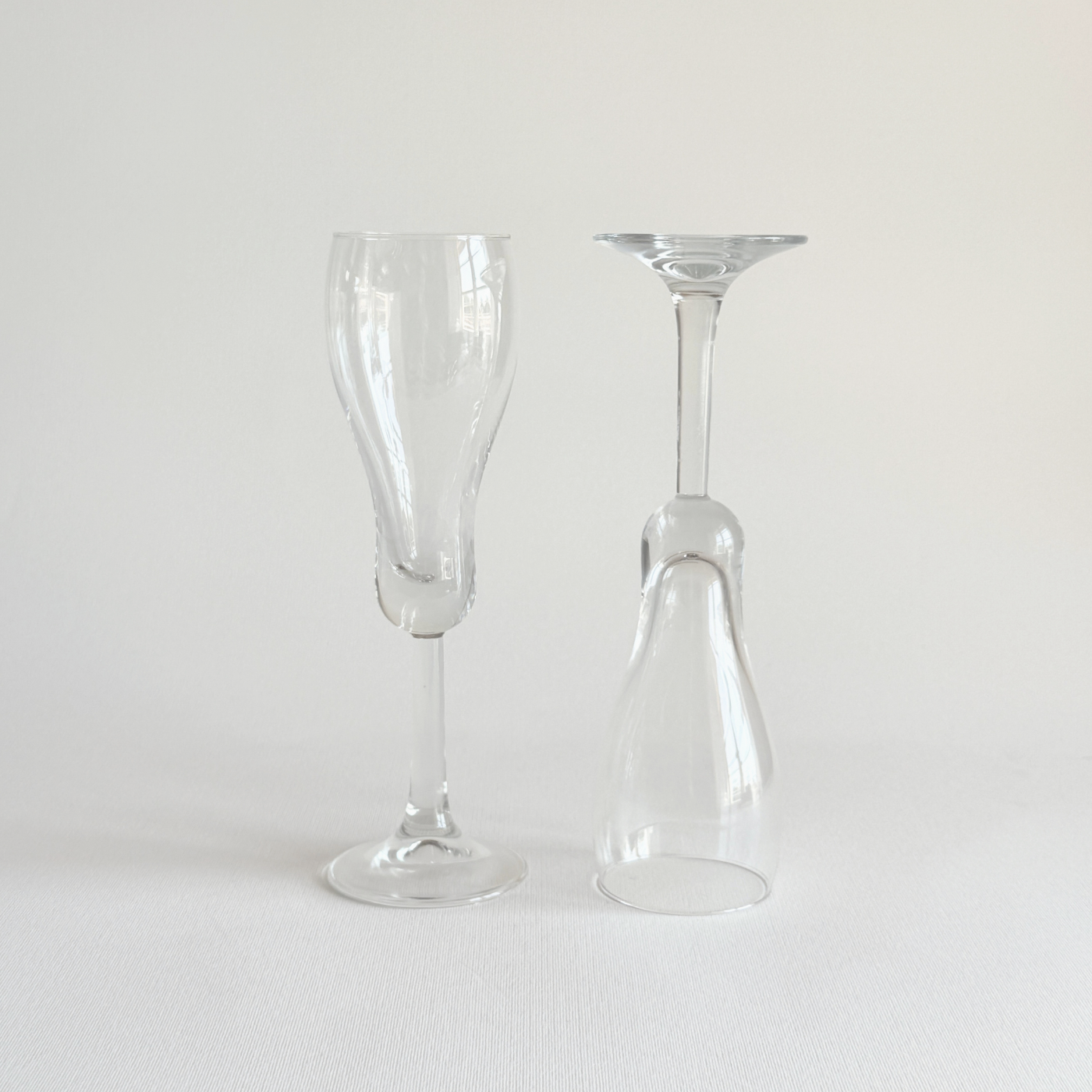 Italian champagne tulip flutes — close-up of rounded base showing distinctive curved foot, approx. 75g per glass