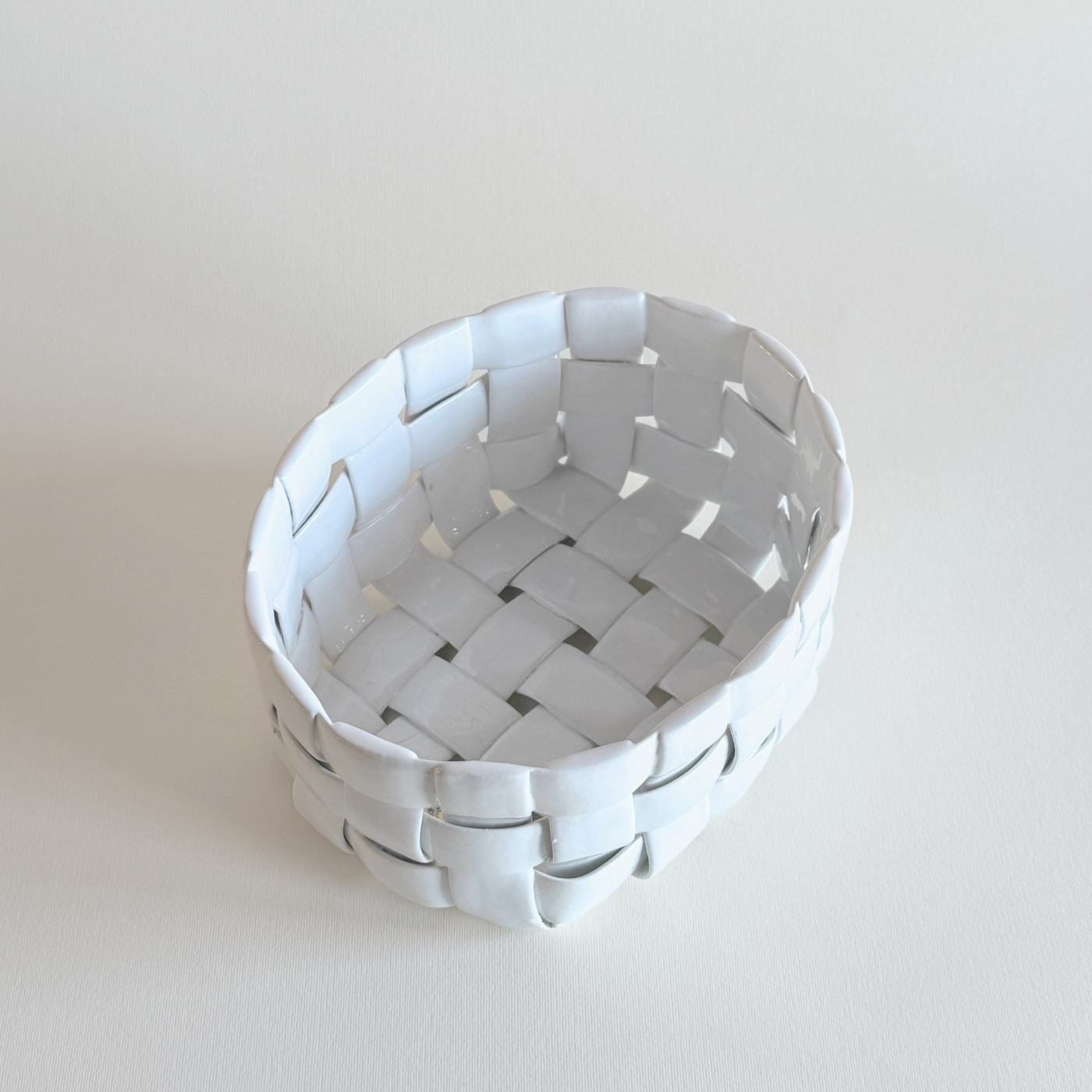 White ceramic woven display basket, pierced lattice detail