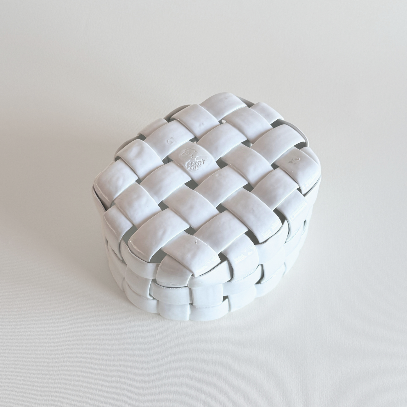 White-glazed porcelain basket interior with pierced lattice base
