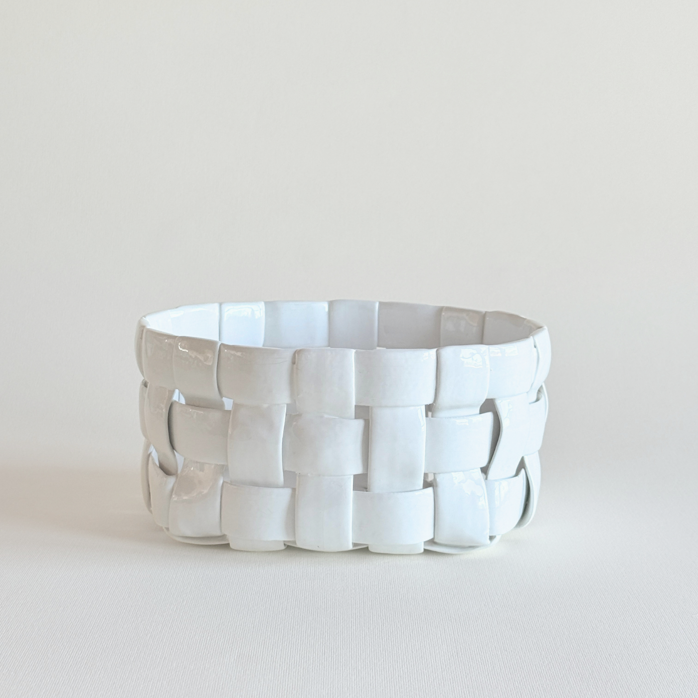 White Italian porcelain woven basket with pierced openwork lattice, 1990s