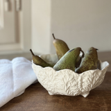 wedgwood country ware bowl coalport with  pears on a wooden surface.