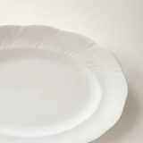 Base of white oval porcelain serving dish — unglazed foot ring, clean underside, no marks
