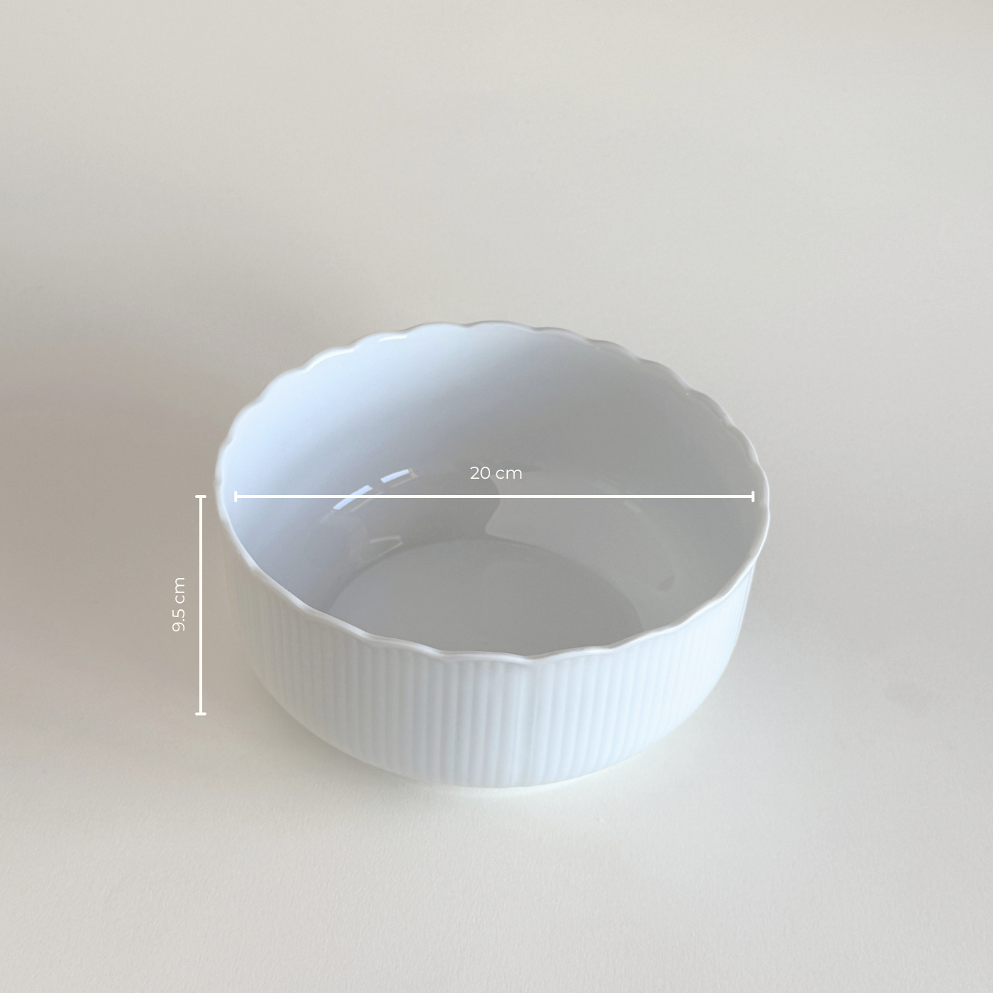 White ceramic bowl with scalloped edge 