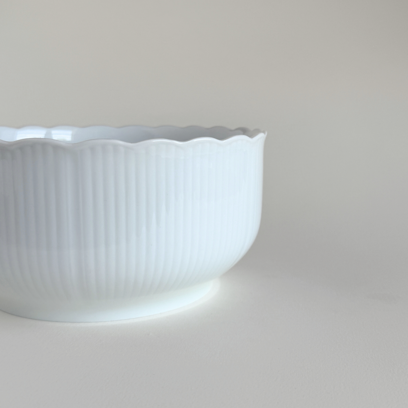 White ceramic bowl with scalloped edge 