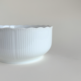 White ceramic bowl with scalloped edge 