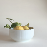 White ceramic bowl with scalloped edge with lemons