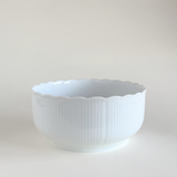 White ceramic bowl with scalloped edge 