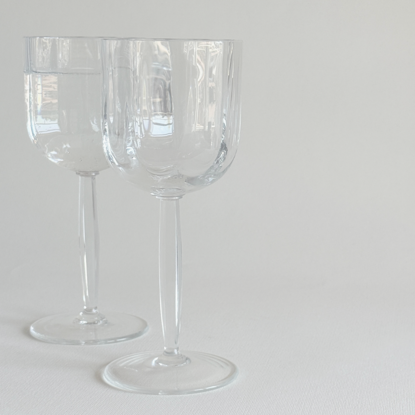 Italian ribbed white wine glasses — angled view showing profile of ribbed bowl and geometric stem together