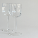 Italian ribbed white wine glasses — angled view showing profile of ribbed bowl and geometric stem together